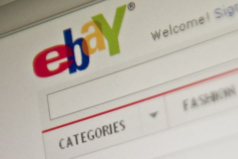 The eBay homepage appears on a screen in