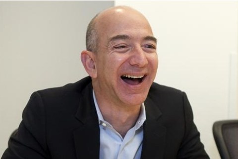 Jeff Bezos holds an interview with Reuters next to a Kindle in Cupertino