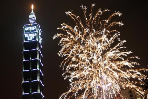 Fireworks explode beside the world's tallest completed skyscraper Taipei 101 during New Year celebrations in Taipei