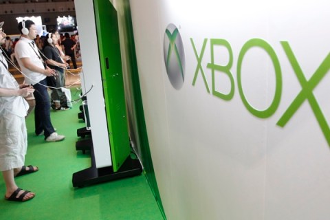 Visitors play with Microsoft's Xbox 360 consoles at the Tokyo Game Show in Chiba