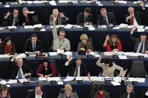 Members of the European Parliament vote during a voting session at the European Parliament in Strasbourg