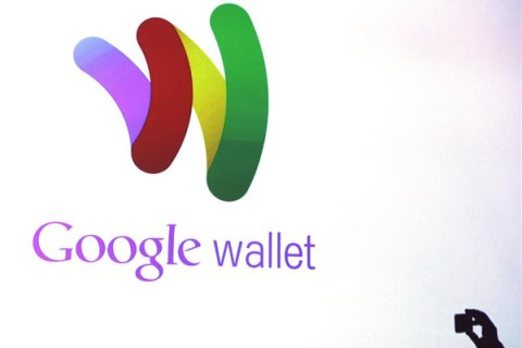 An attendee takes a photo of the Google wallet application screen during a news conference unveiling the mobile payment system in New York