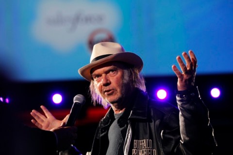 Canadian music legend Neil Young gestures as he address attendees at the Dreamforce event in San Francisco