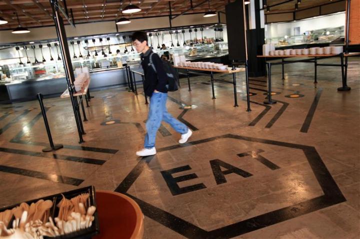 An employee walks through the cafeteria