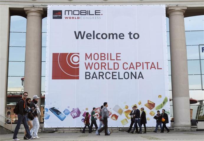 People walk by main entrance of the Mobile World Congress in Barcelona