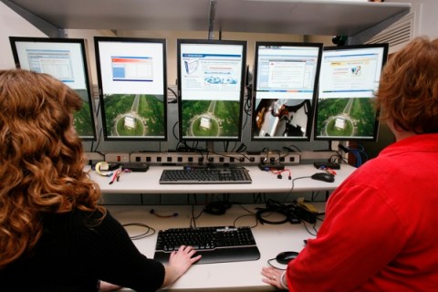FTC investigators look at images in the internet lab at the FTC in Washington
