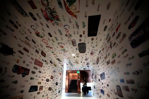 A woman walks past a tunnel of Google homepage logos at the Google campus near Venice Beach, in Los Angeles