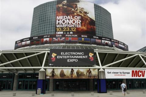 A man walks past signs in place for E3 2012