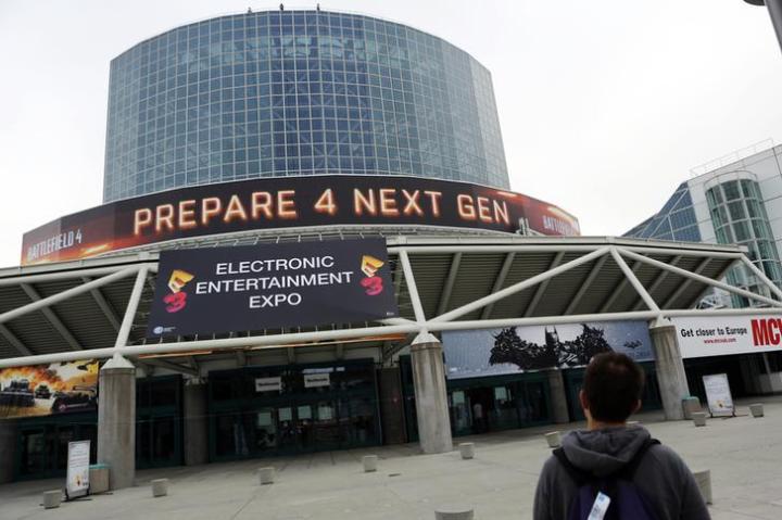 A man walks past signage outside E3 2013 in Los Angeles, California