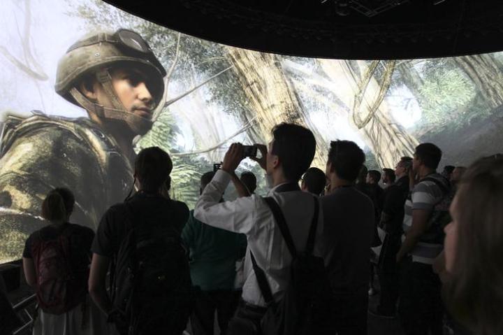 People watch a demonstration of Call of Duty at the Activision exhibit at E3, the Electronic Entertainment Expo, in Los Angeles