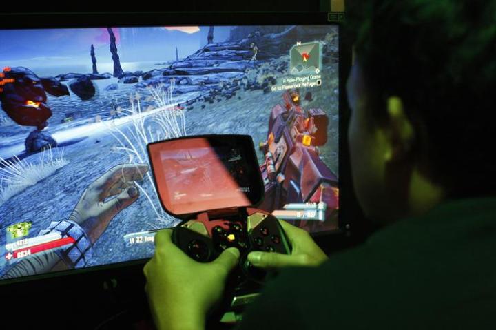 A man tries a game at the Nvidia Shield PC Game Streaming exhibit at E3, the Electronic Entertainment Expo, in Los Angeles, California.